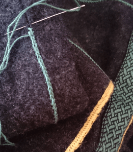 Decorating the seams and hems of an apron dress. 