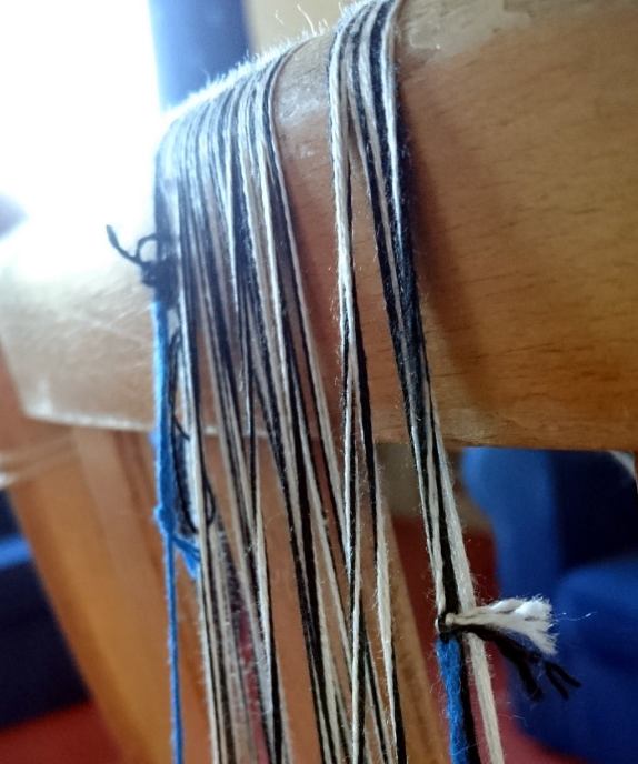 threads over a wooden bar